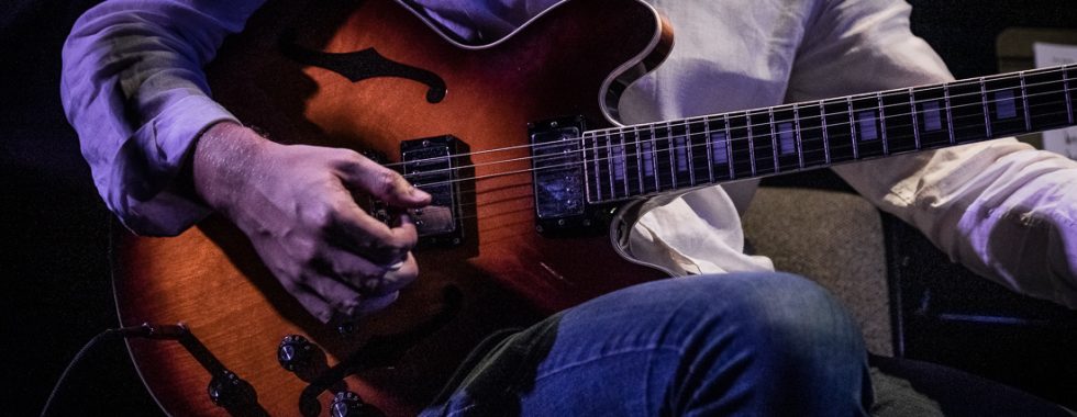 man plays guitar