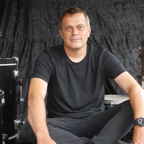 Dave Sanders sitting by some drums