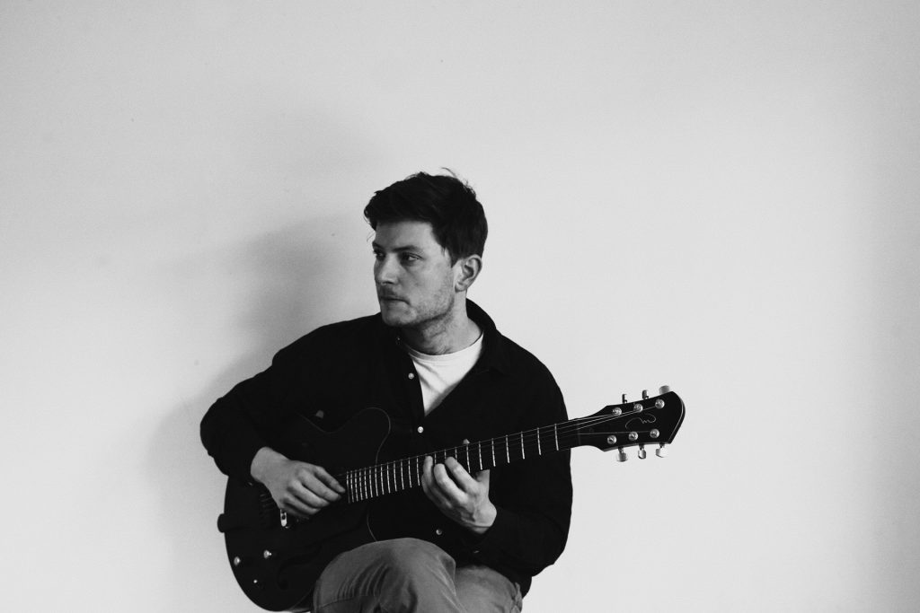 Tom Ollendorf playing guitar