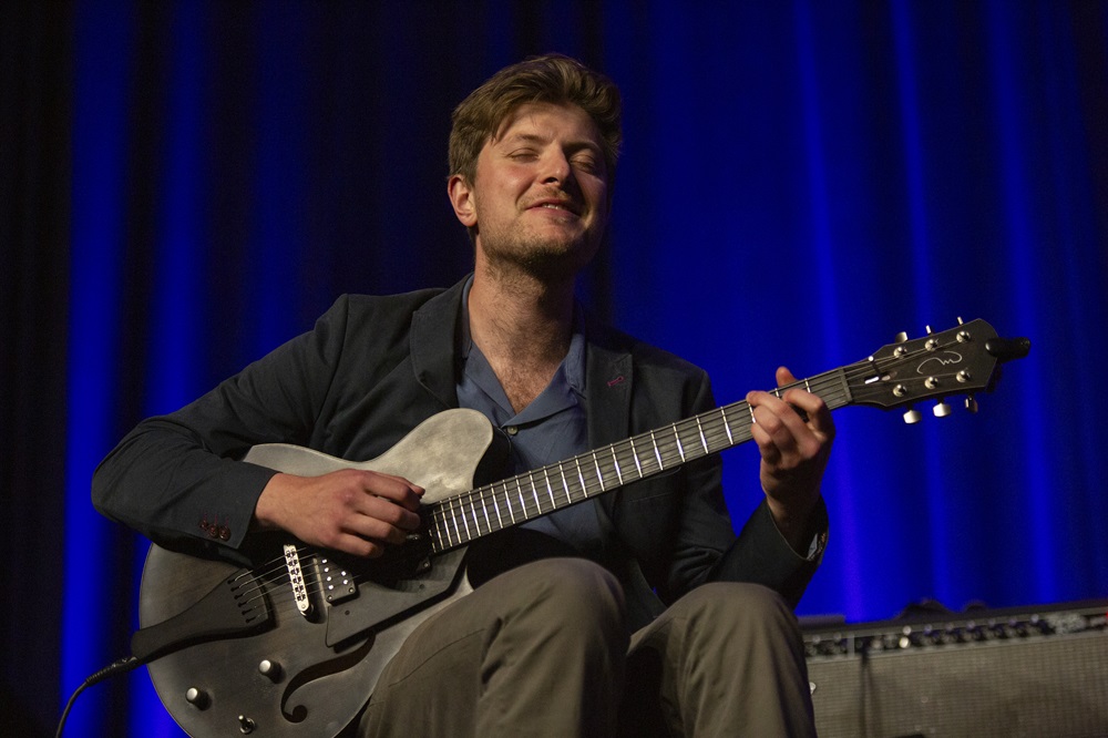 Tom Ollendorff playing guitar