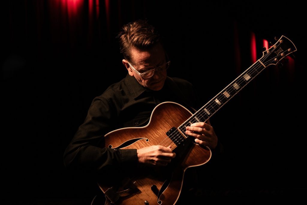 james sherlock playing guitar on stage